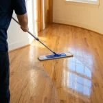 How to clean hardwood floors: a warm oak hardwood floor in a sunny hallway