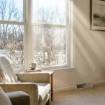 How to reduce dust in house: sunbeams through a living-room window showing floating dust particles