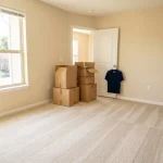 Move out carpet cleaning: an empty bright apartment bedroom with freshly cleaned carpet showing even vacuum lines